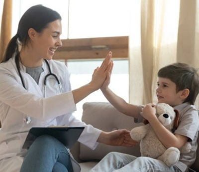Family registering for healthcare services at clinic front desk.